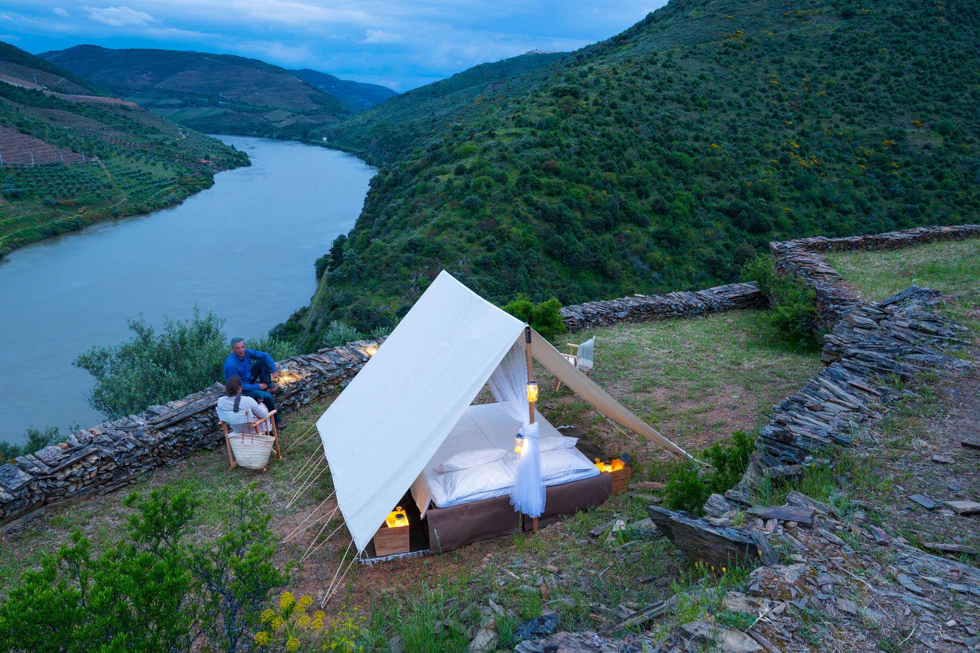 A tent set up in scenic surroundings by a river in Faia Brava in Portugal. An example of tourism and rewilding efforts being combined.