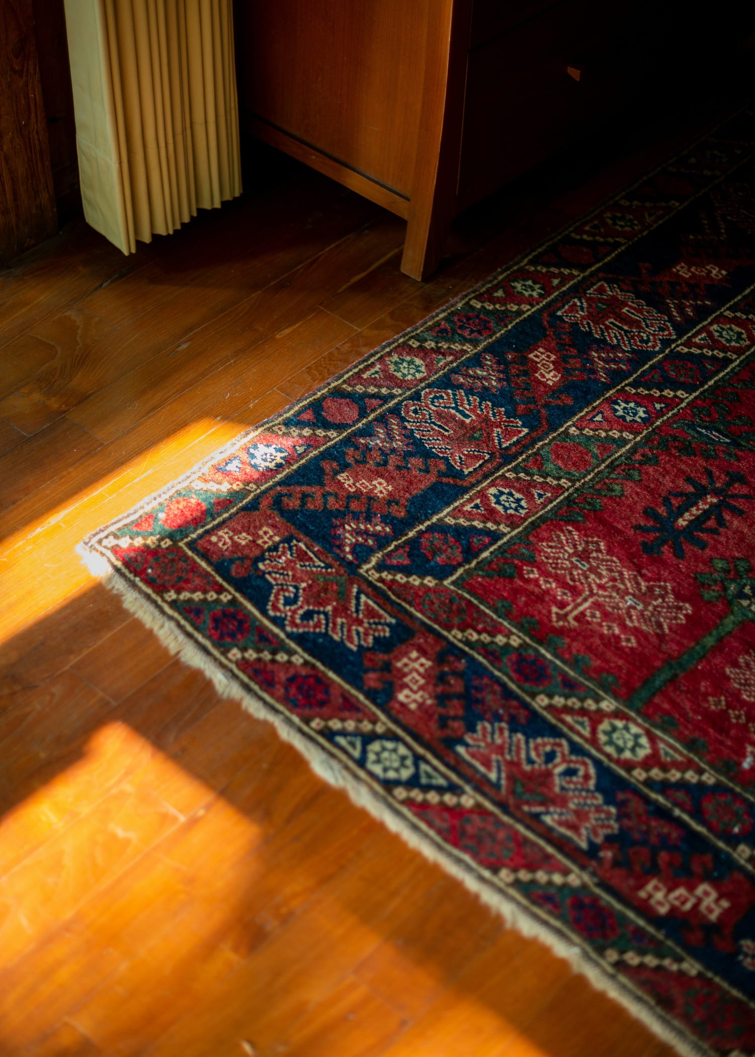 Sunlight hitting a rug on wooden floor. Sustainably designed