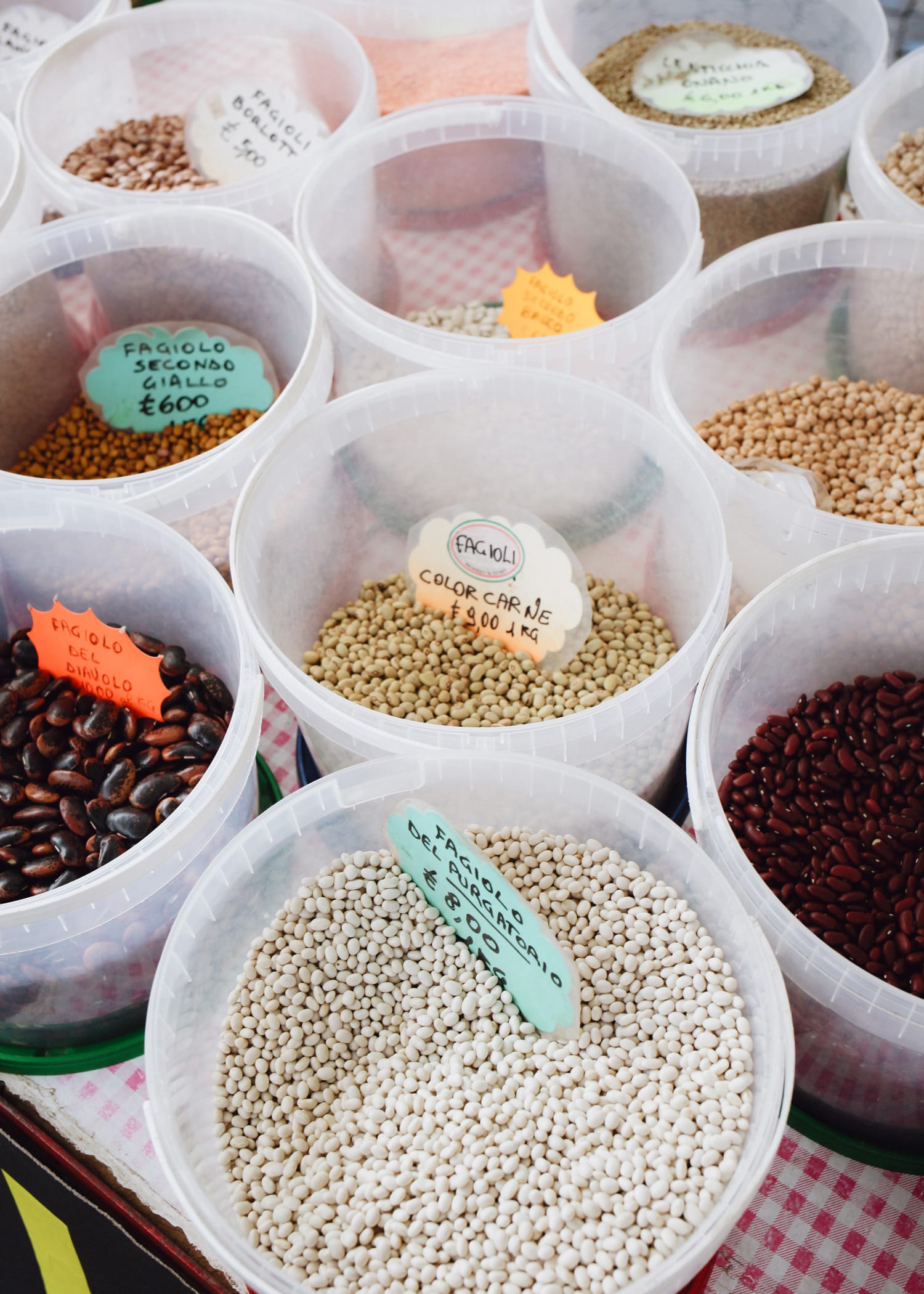 buckets with different kinds of legumes which are amongst the best vegan protein sources