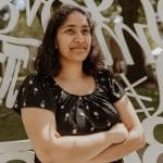 priya donti standing arms folded