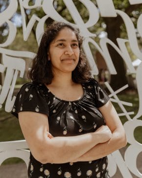 priya donti standing arms folded