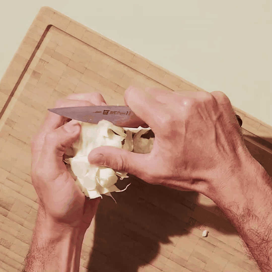 cutting a cauliflower without waste on a cutting board